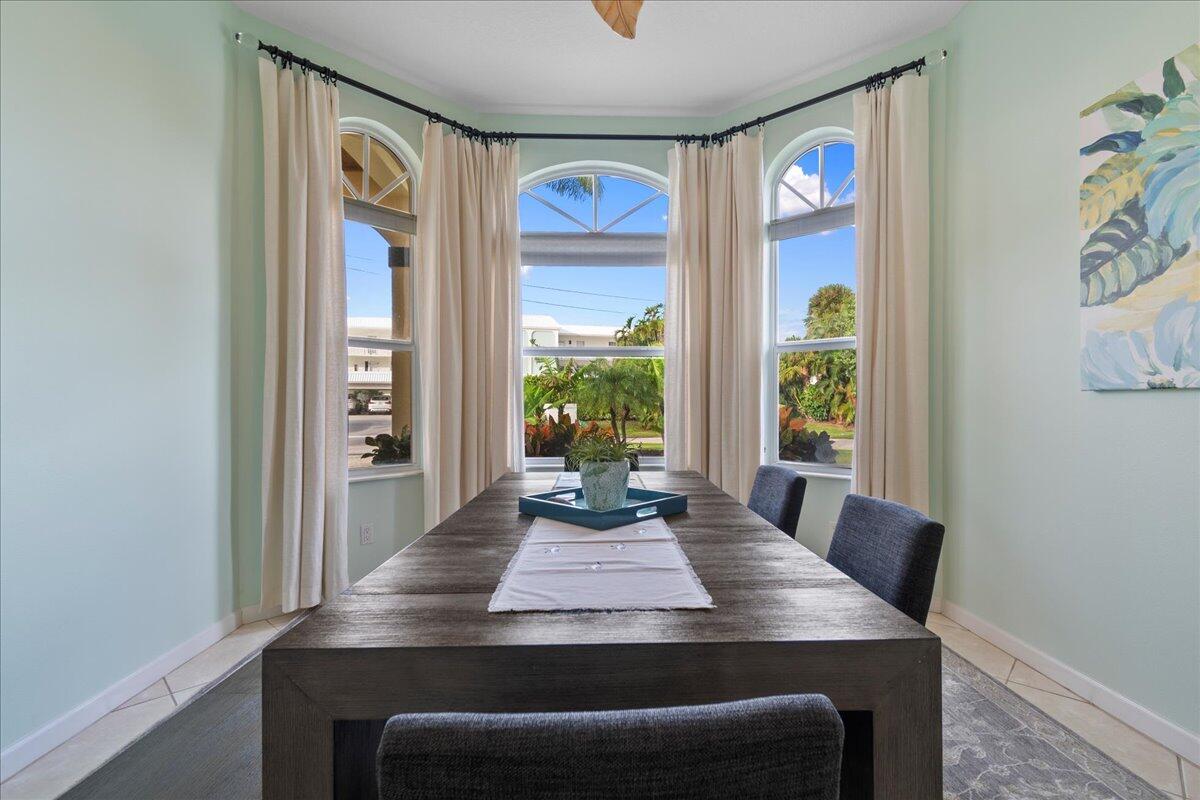 72 Waterway Road Jupiter, FL 33469 - Photo 10 of 57 a view of a dining table and chairs in a room