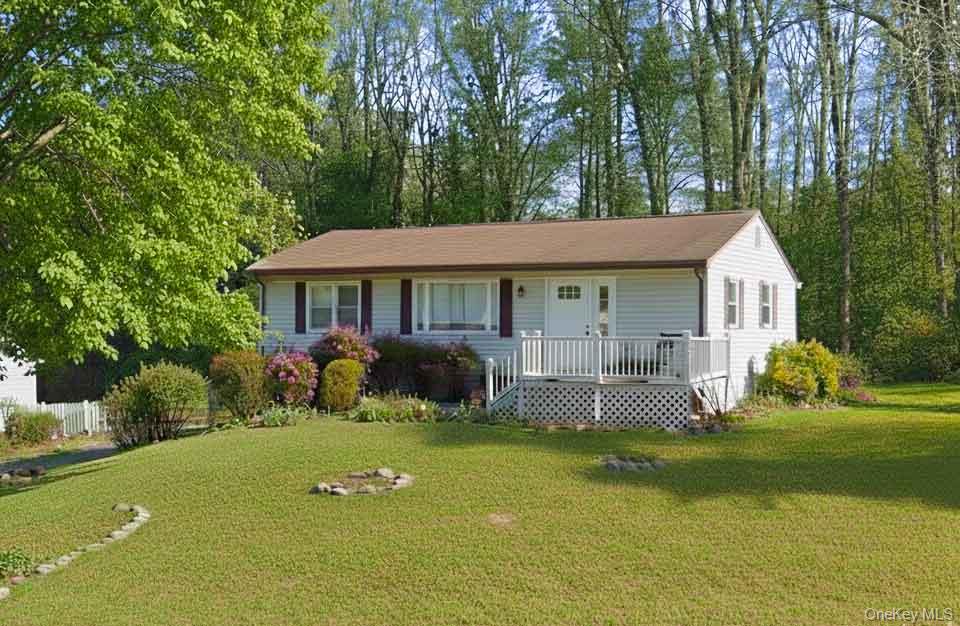 Ranch-style home featuring a front yard