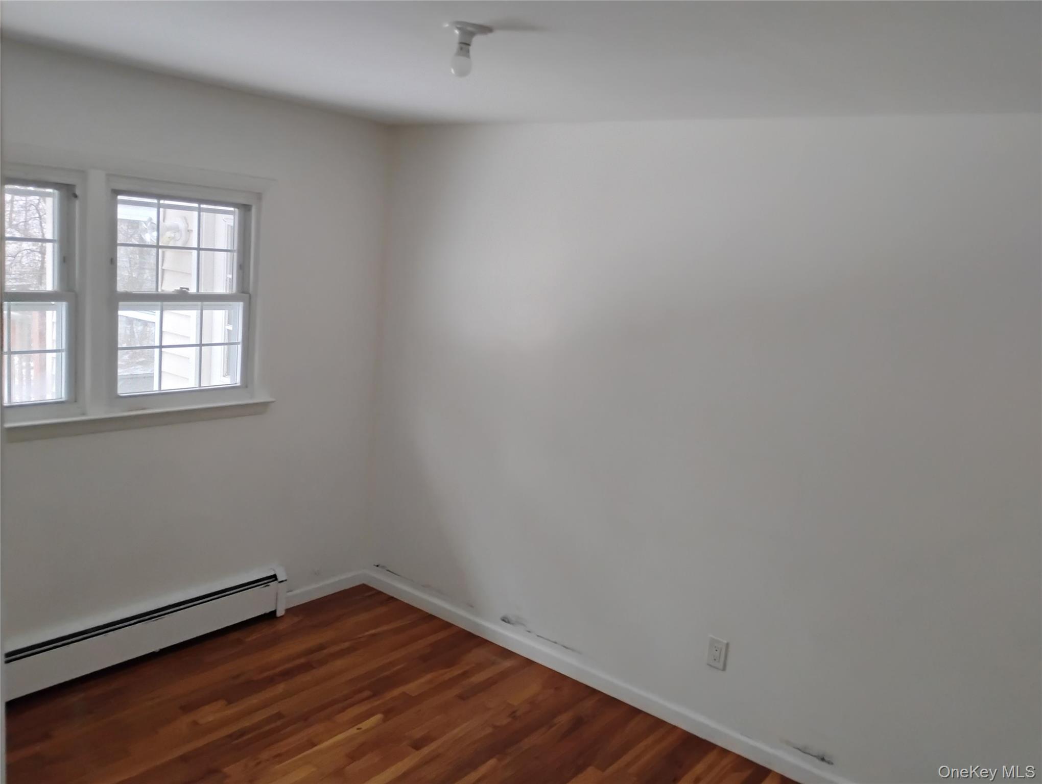 9 Merriewold Lane South Monroe, NY 10950 - Photo 10 of 14 bedroom with baseboard heating and dark wood finished floors
