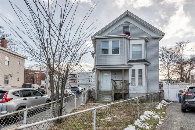 a front view of a house with parking space
