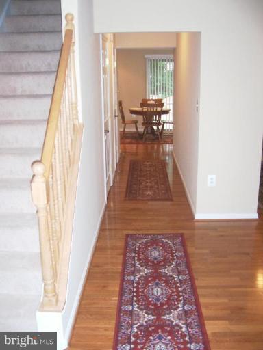 2936 Jermantown Road, Unit 10 Oakton, VA 22124 - Photo 3 of 7 a view of a bedroom with wooden floor and furniture