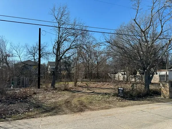 a view of a yard with wooden fence