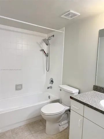 a bathroom with a toilet sink and shower