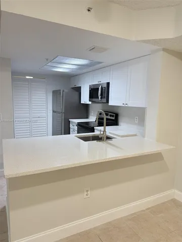 a bathroom with a sink a large mirror and a shower