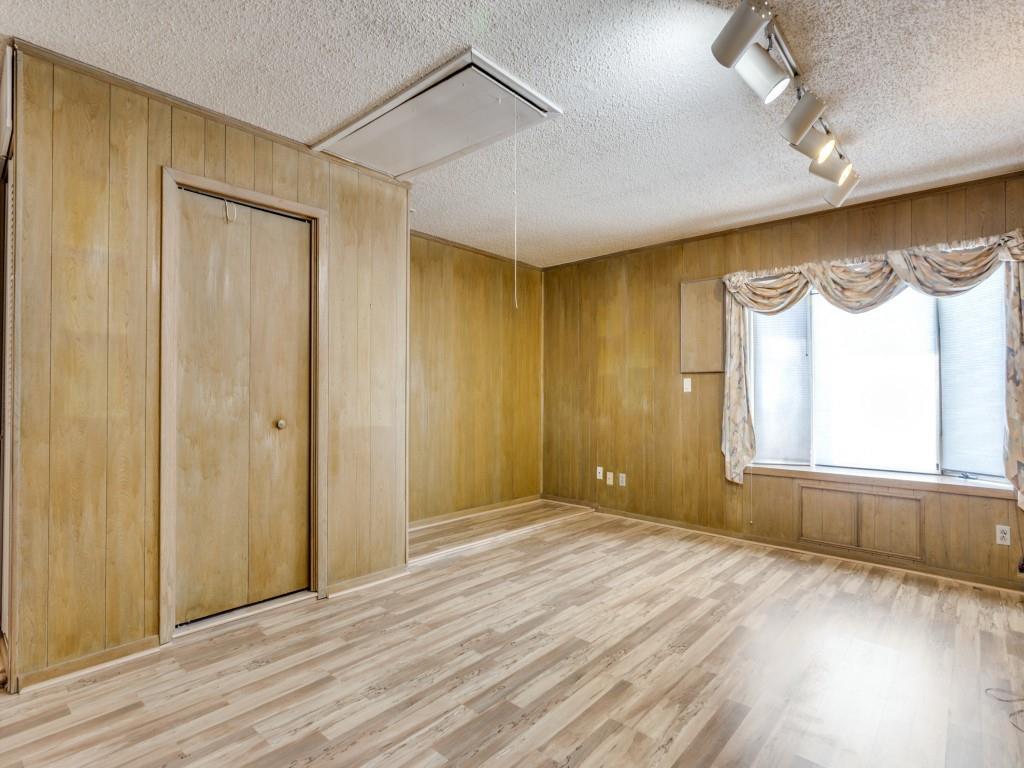 1216 Manning Street Benbrook, TX 76126 - Photo 11 of 26 Spare room with attic access, wood walls, light wood-style floors, a textured ceiling, and rail lighting
