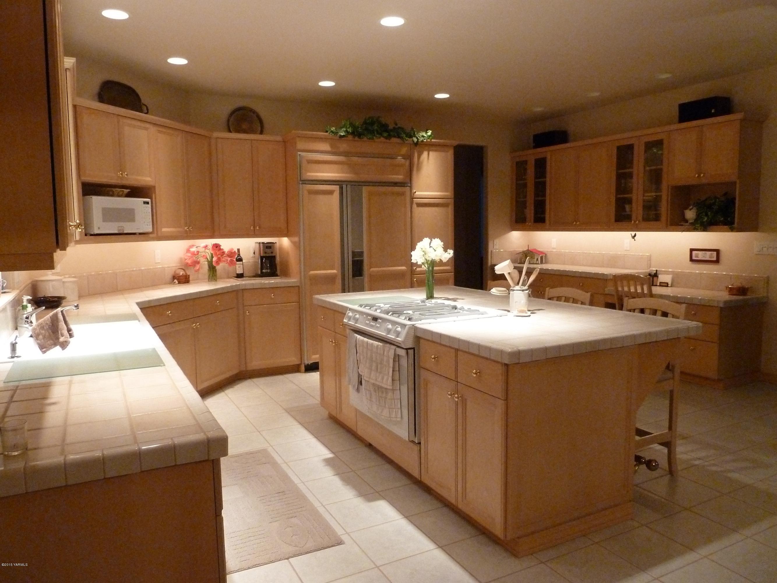 14000 Marble Road Yakima, WA 98908 - Photo 7 of 22 a kitchen with stainless steel appliances kitchen island granite countertop a sink and a refrigerator