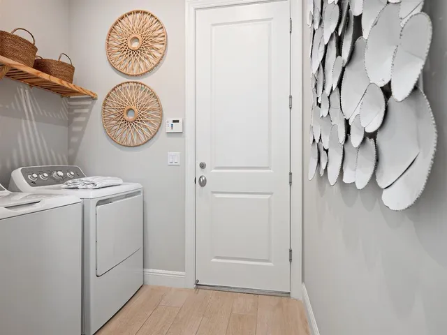 a view of a hallway with washer and dryer