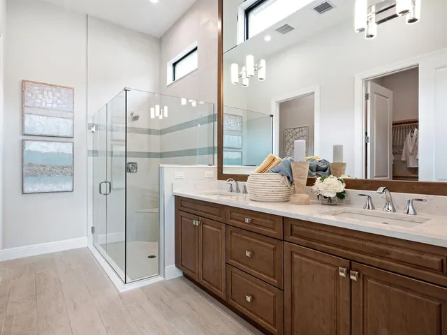 a bathroom with a double vanity sink and mirror