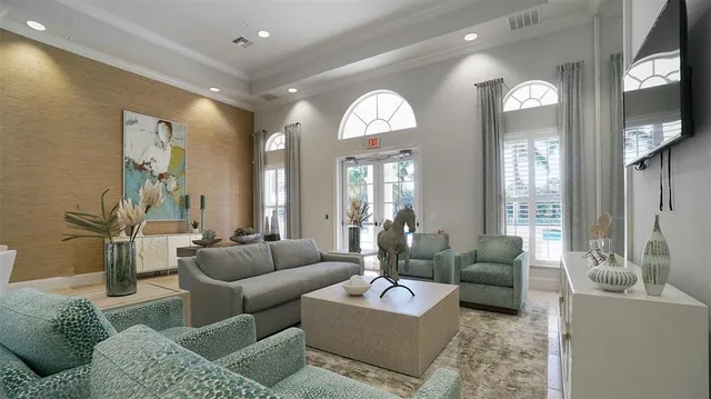 a living room with furniture and a large mirror