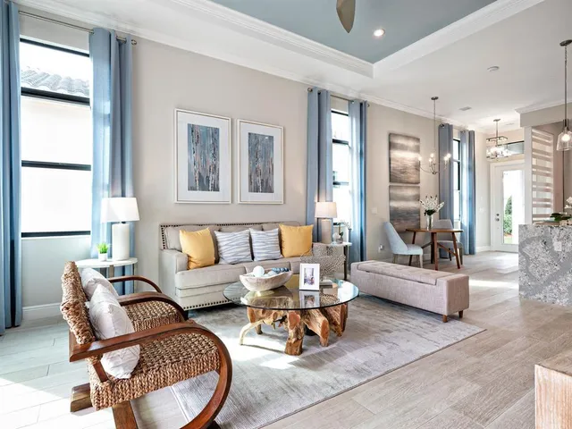 a living room with furniture and large windows