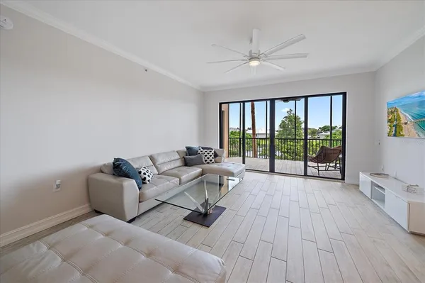 a living room with furniture and a floor to ceiling window