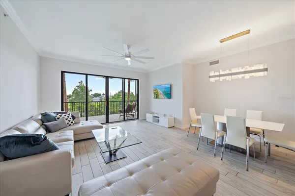 a living room with furniture and kitchen view