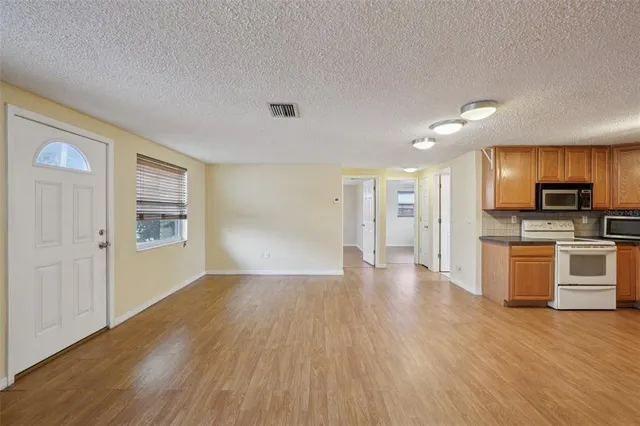 a view of a kitchen with a sink and a stove top oven