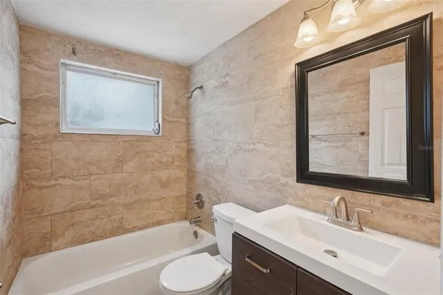 a bathroom with a sink toilet and bathtub