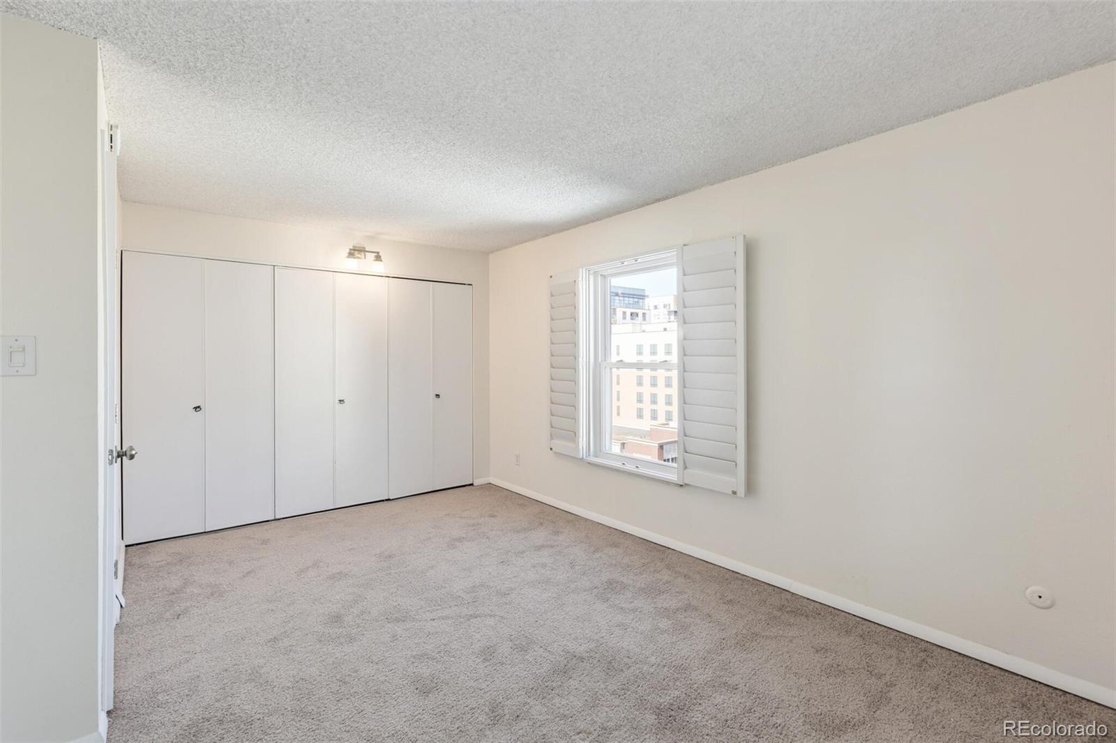 2 Adams Street, Unit 910 Denver, CO 80206 - Photo 11 of 15 an empty room with a empty space and windows