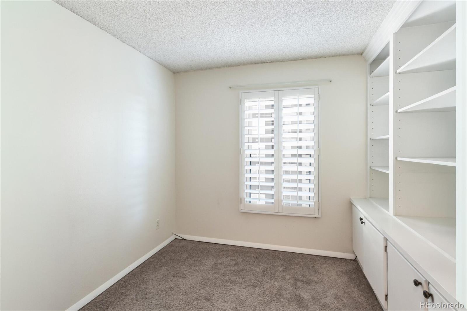 2 Adams Street, Unit 910 Denver, CO 80206 - Photo 9 of 15 a view of an empty room with a window