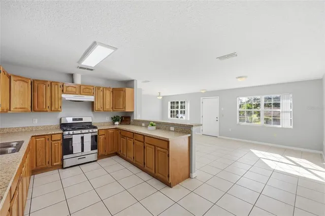 a kitchen with stainless steel appliances granite countertop a stove and a sink