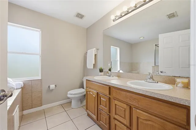a bathroom with a granite countertop sink and shower