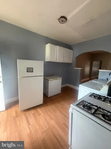 a kitchen with a stove and a refrigerator