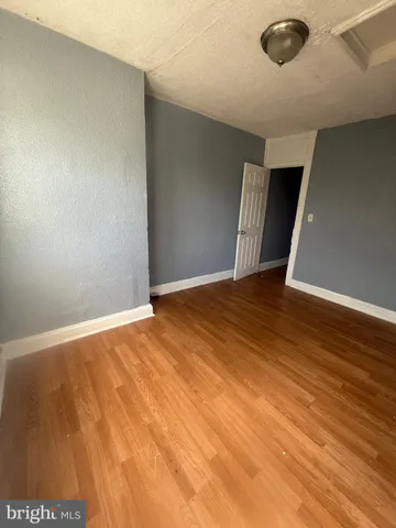 an empty room with wooden floor