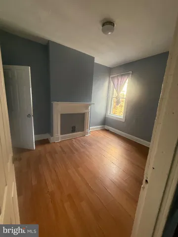a view of empty room with window and fireplace