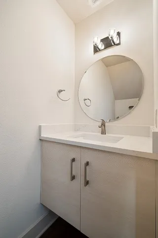 a bathroom with a sink and mirror