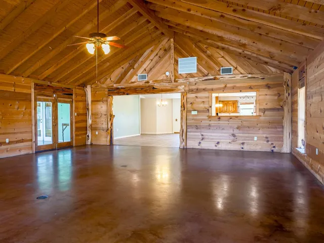 a view of a hall with wooden floor