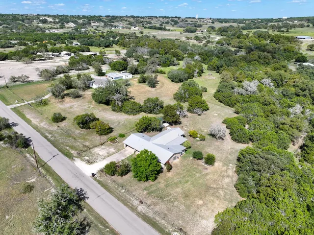 an aerial view of a house with a lake view