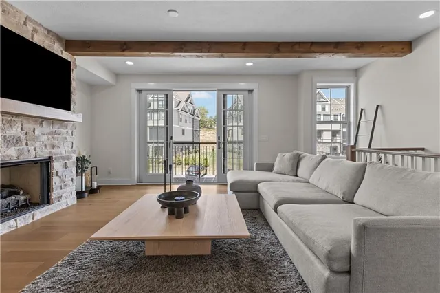 a living room with furniture a flat screen tv and a fireplace