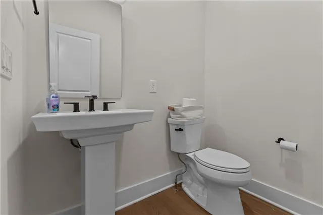 a bathroom with a sink a toilet and mirror