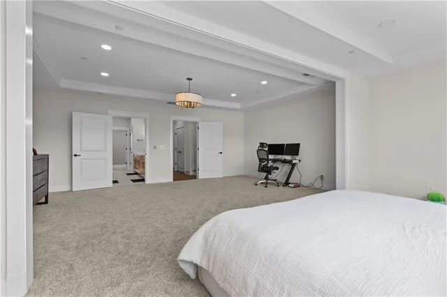 a bedroom with a bed and a large mirror