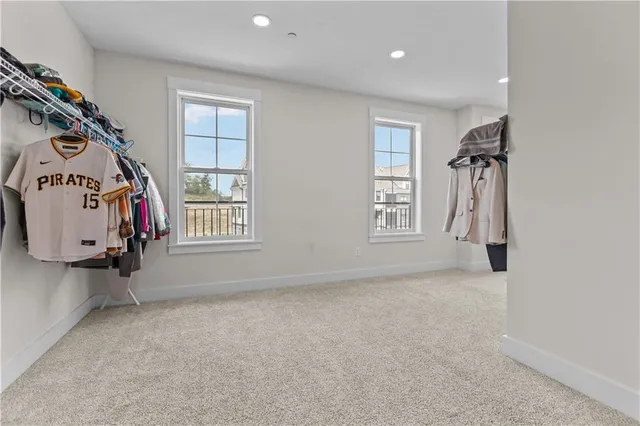 an empty room with windows and closet