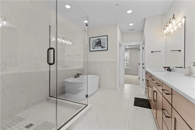 a bathroom with a double vanity sink toilet mirror and shower
