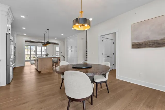 a view of a dining room with furniture and a chandelier