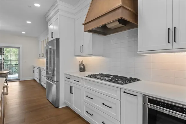 a kitchen with stainless steel appliances granite countertop a stove and a refrigerator
