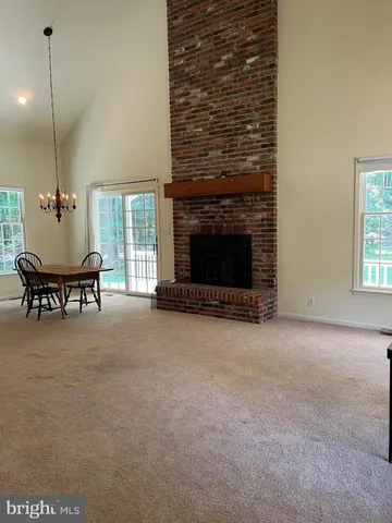 a livingroom with furniture fireplace and a window