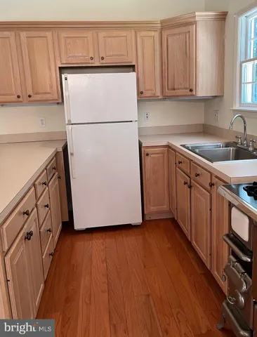 a kitchen with stainless steel appliances a refrigerator sink and cabinets