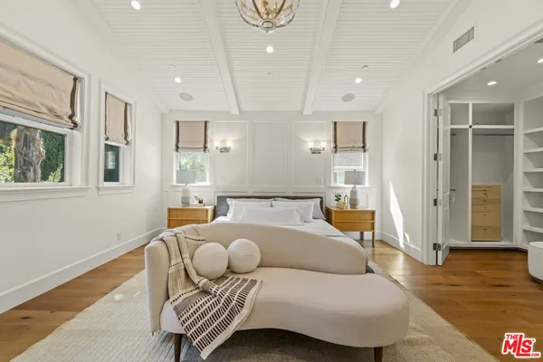 a spacious bedroom with a bed and a fireplace
