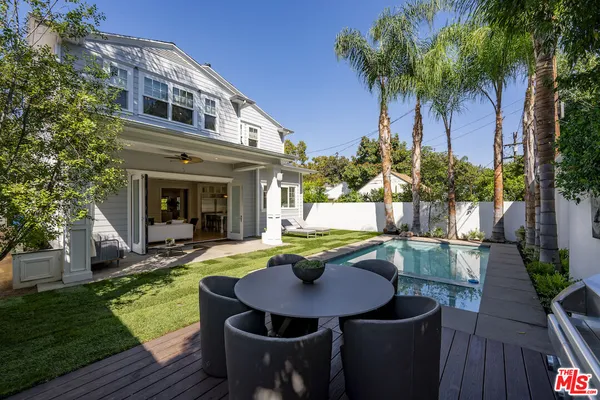 a view of a house with swimming pool and sitting area
