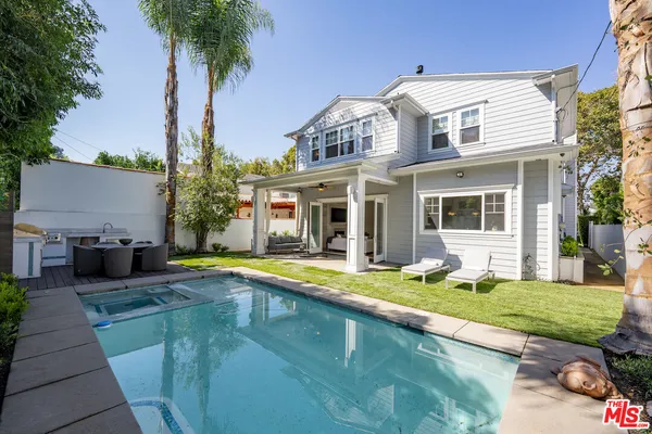 a view of a house with pool yard and front view of a house