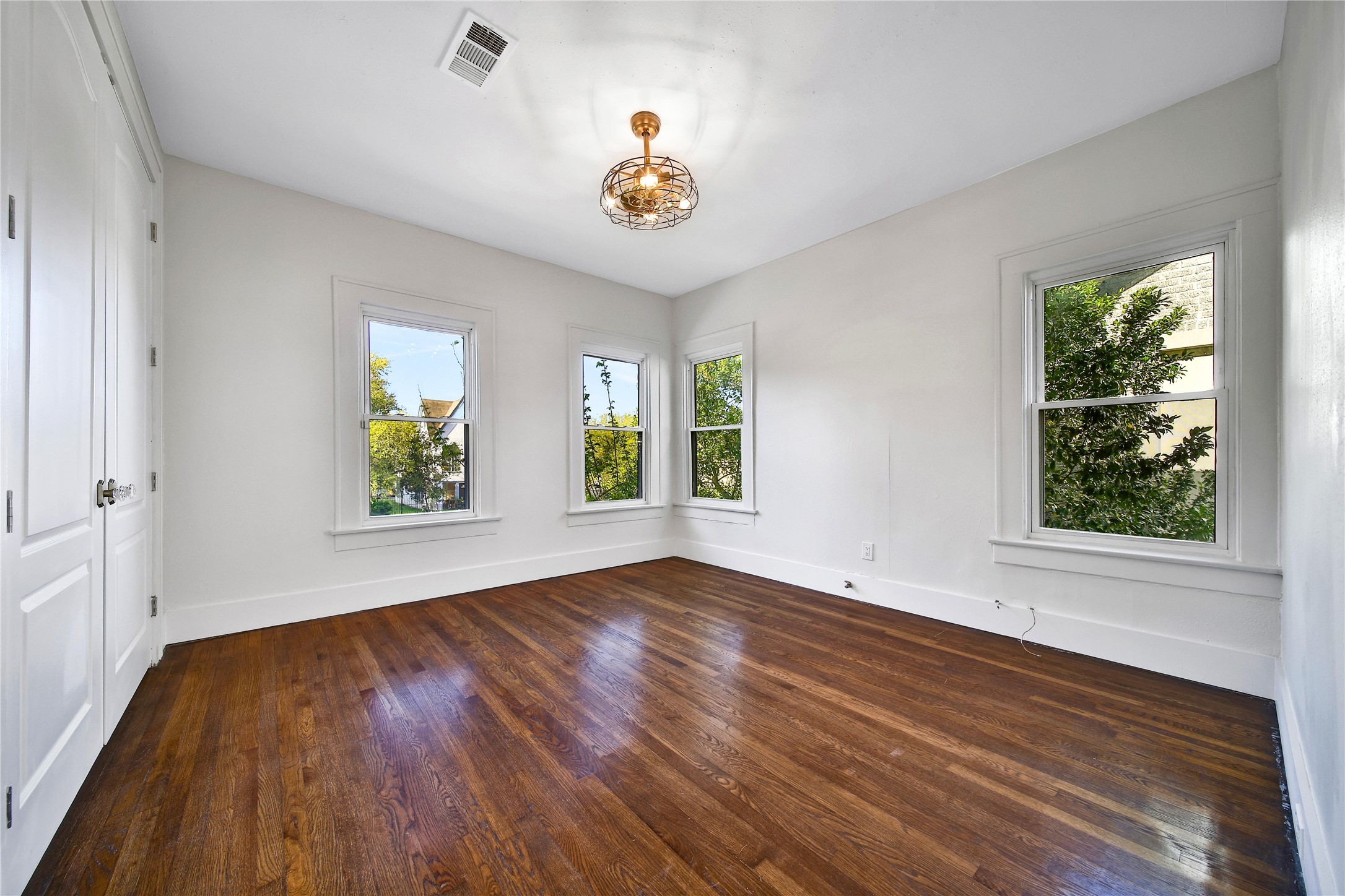 2405 Arbor Street Houston, TX 77004 - Photo 28 of 41 a view of an empty room with a window and wooden floor