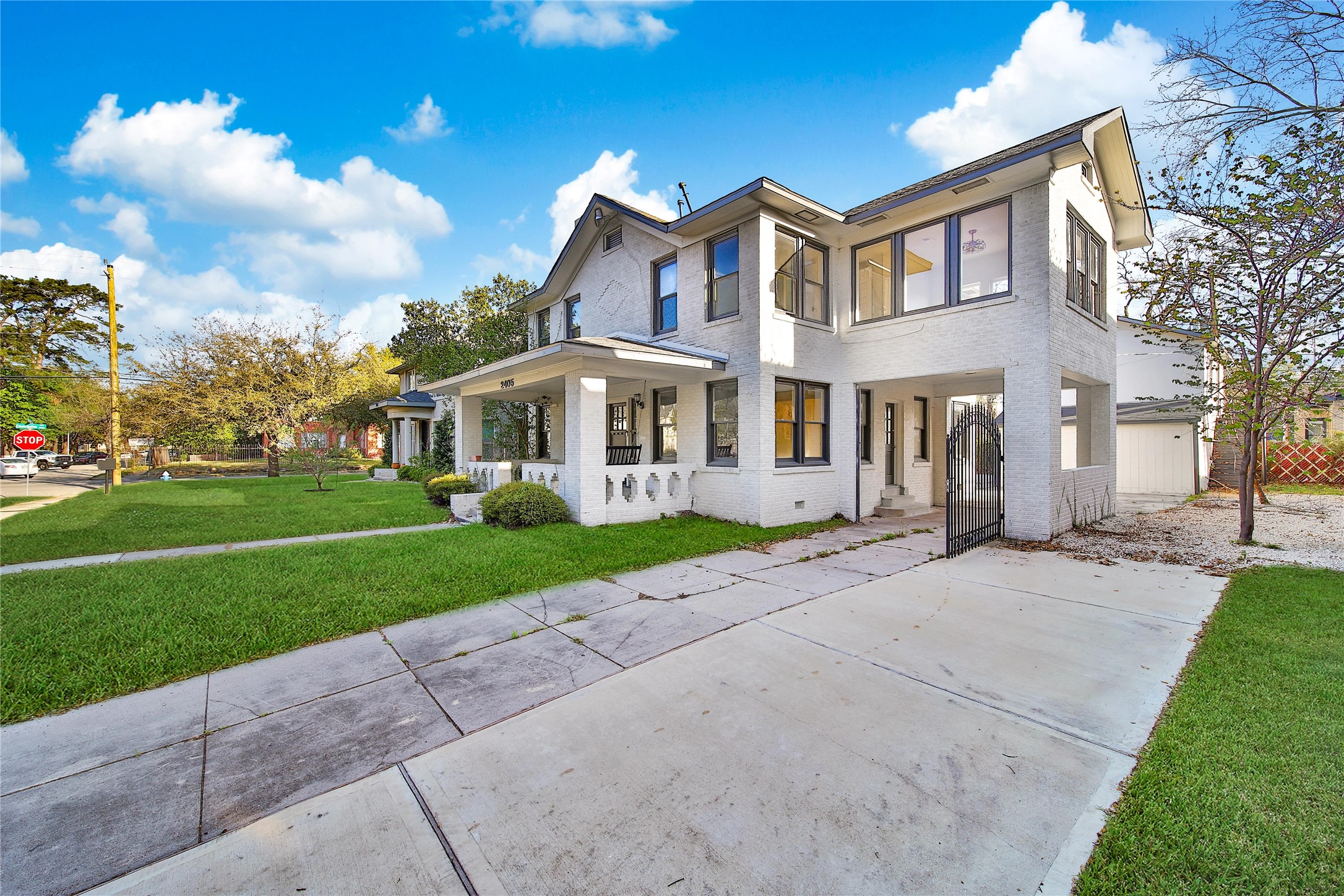 2405 Arbor Street Houston, TX 77004 - Photo 5 of 41 a view of a white house with a big yard and large trees