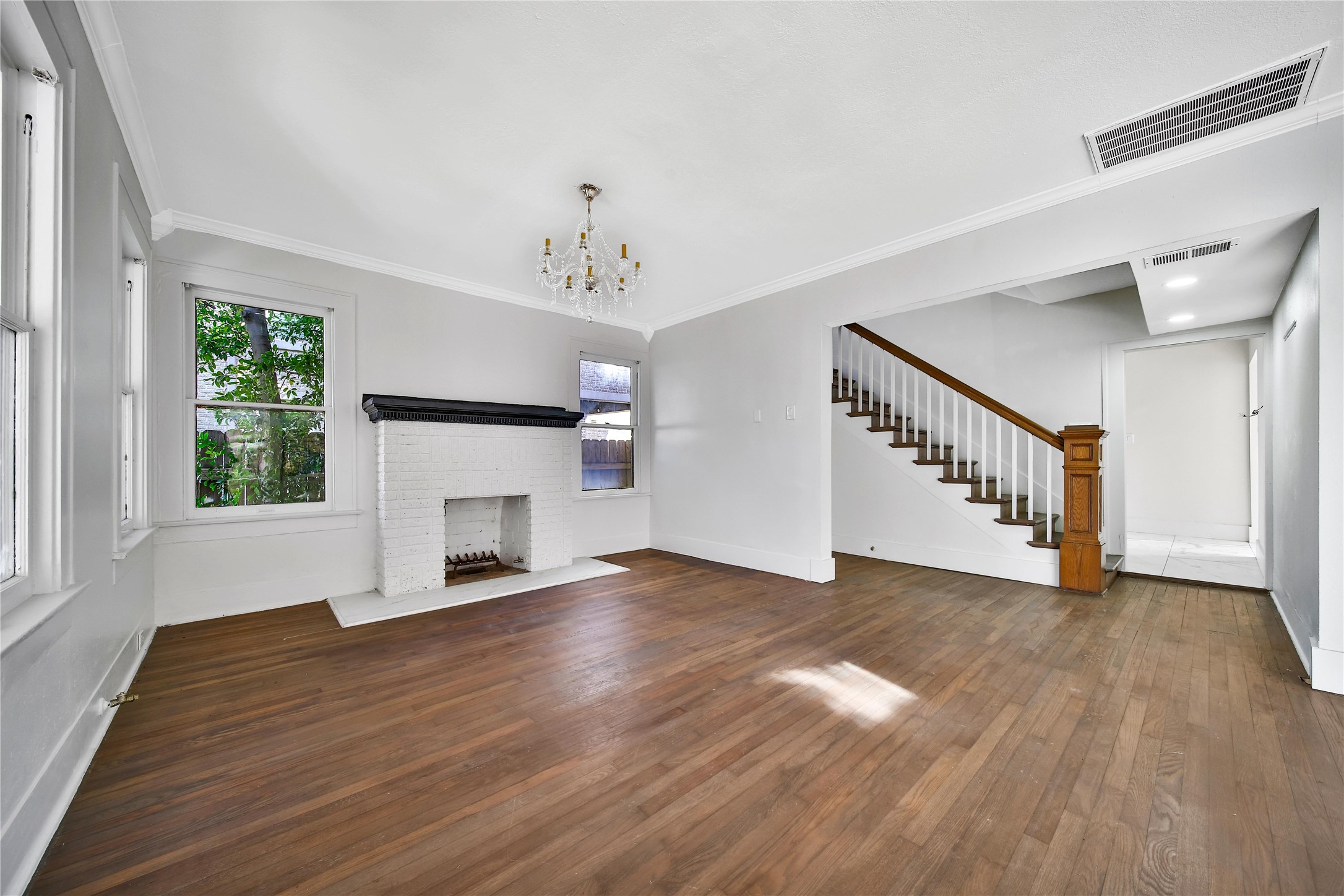 2405 Arbor Street Houston, TX 77004 - Photo 8 of 41 a view of an empty room with wooden floor fireplace and a window