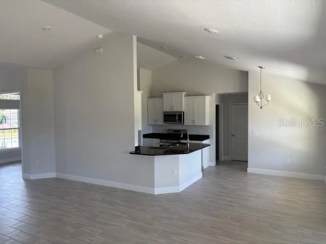 a view of a kitchen with a sink and a stove top oven