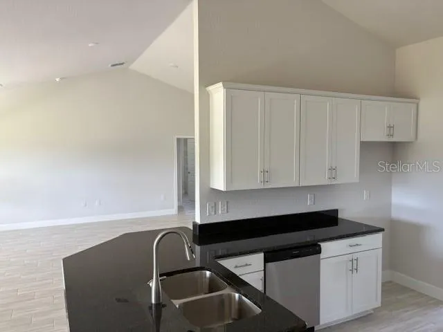 a kitchen with a sink cabinets and a window