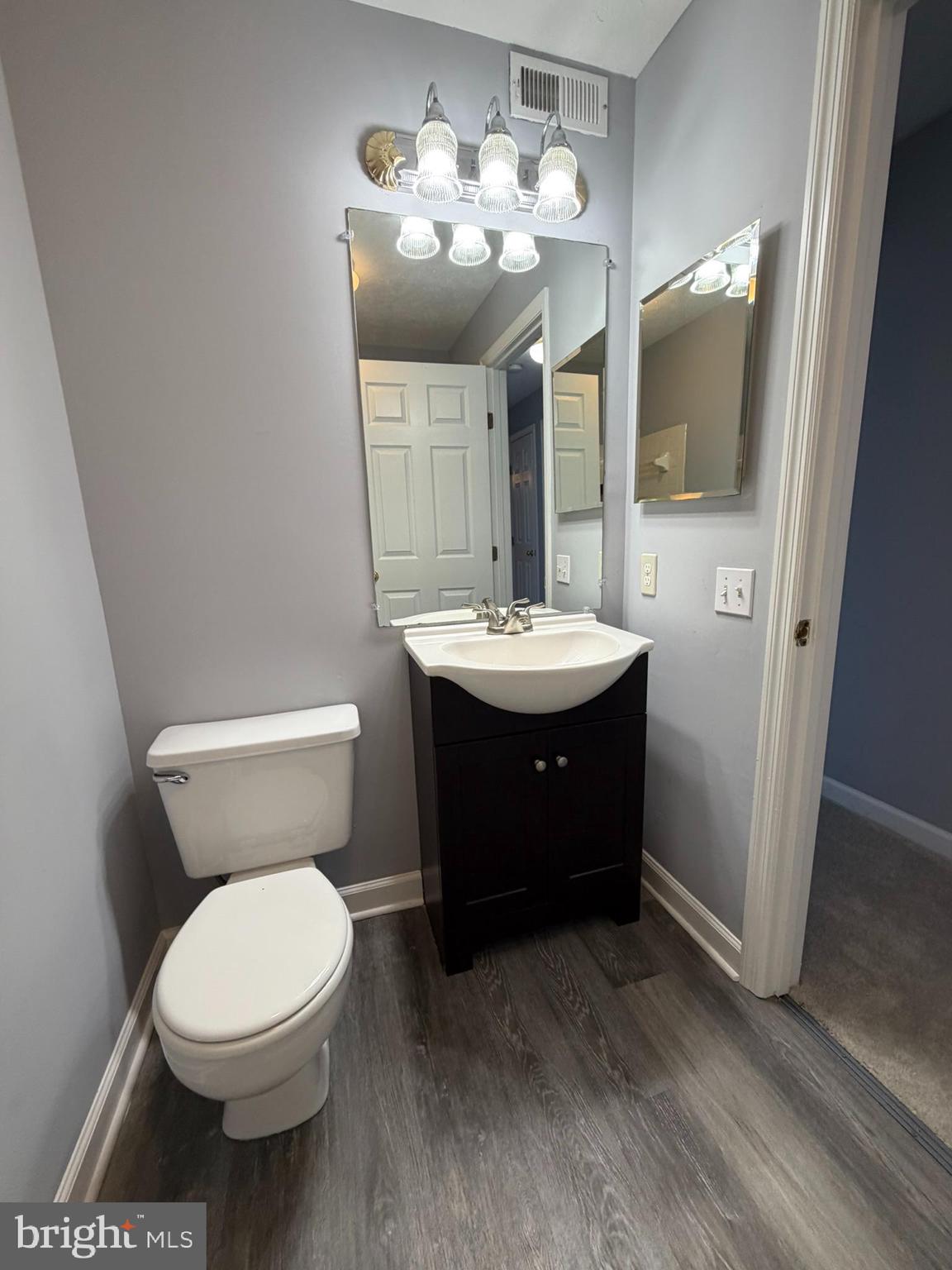 1401 F Sage Lane Belcamp, MD 21017 - Photo 21 of 30 a bathroom with a toilet sink and mirror