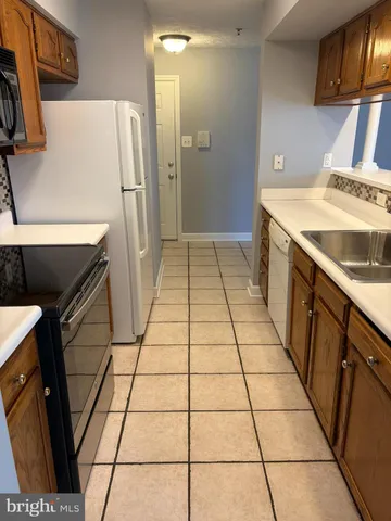a kitchen with a sink a stove and a refrigerator