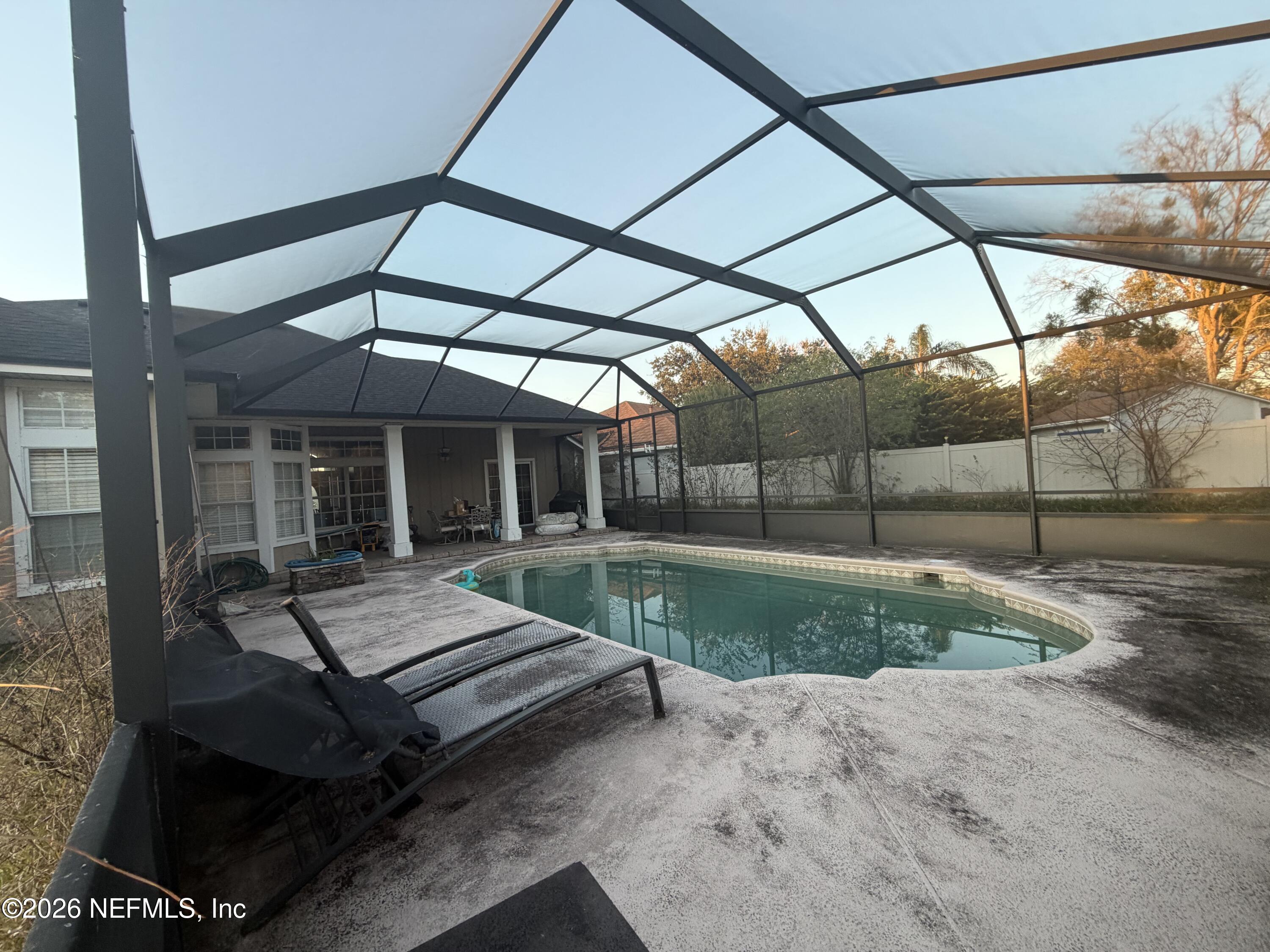 1478 Winston Lane Fleming Island, FL 32003 - Photo 14 of 15 a view of a patio with table and chairs and potted plants