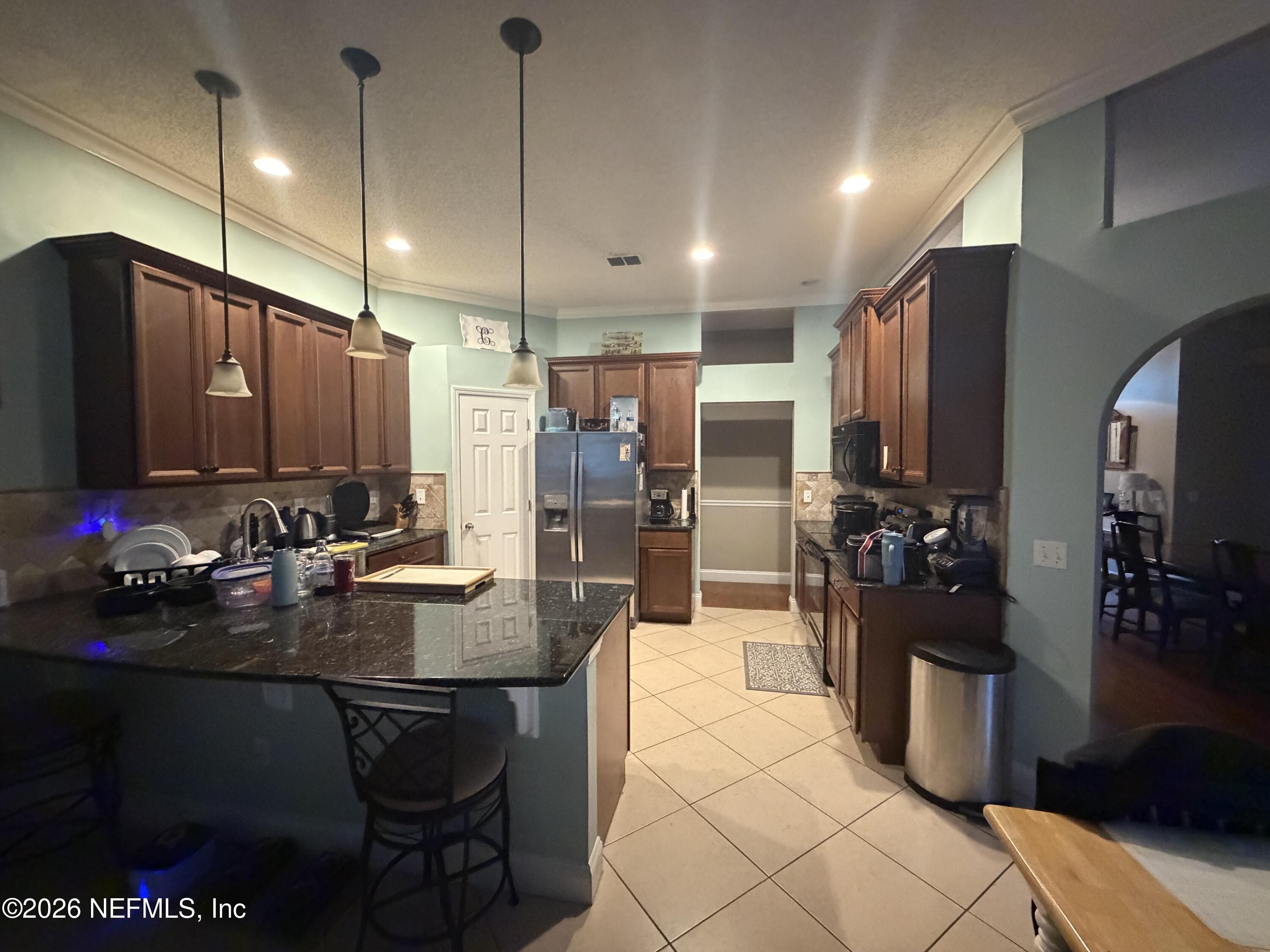 1478 Winston Lane Fleming Island, FL 32003 - Photo 6 of 15 a kitchen with a refrigerator a stove and a sink
