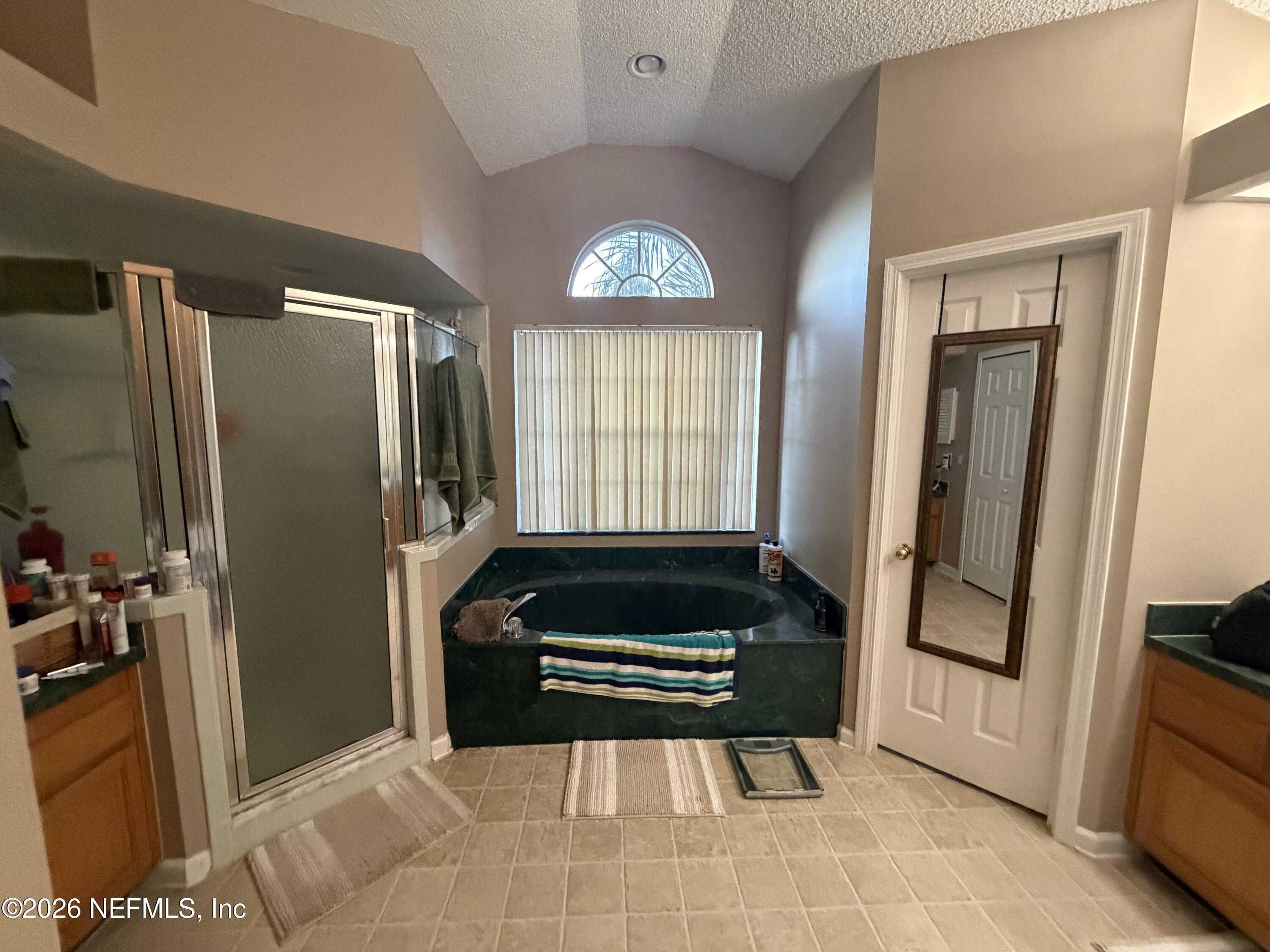 1478 Winston Lane Fleming Island, FL 32003 - Photo 8 of 15 a living room with a couch and a refrigerator